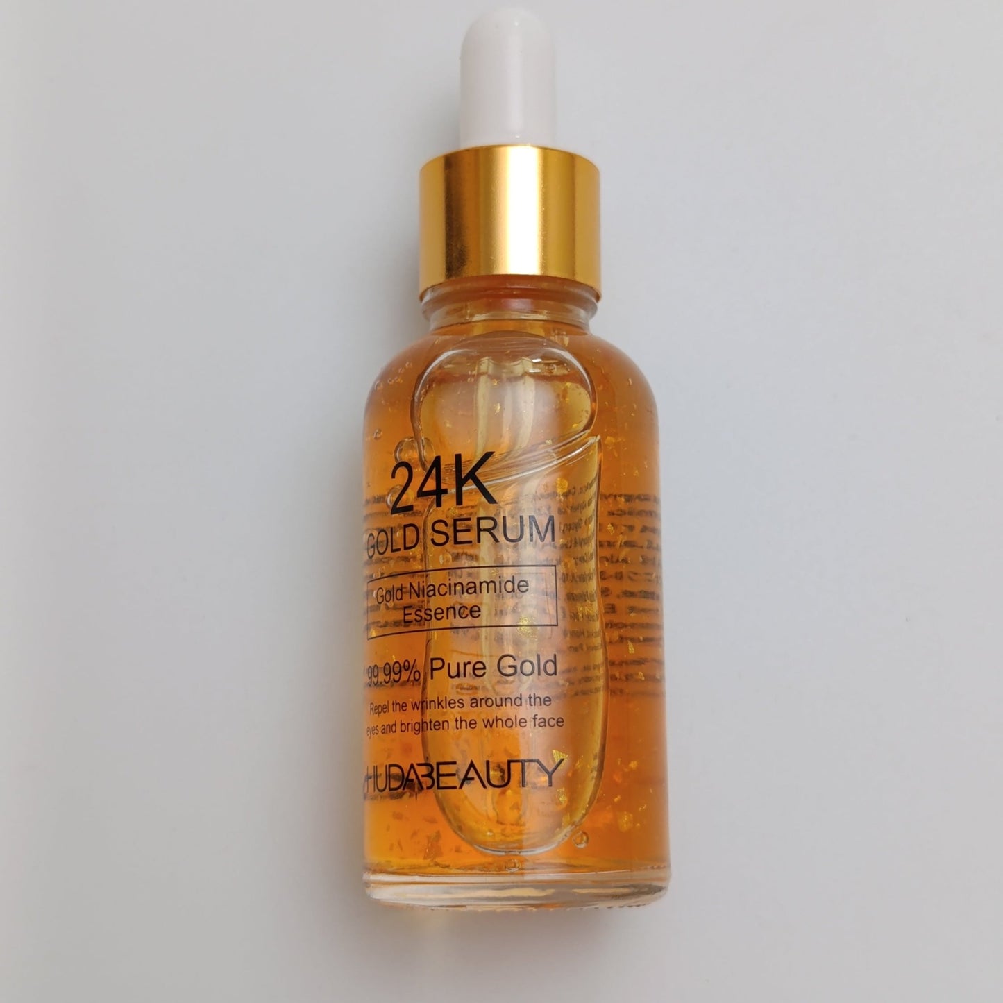 Huda Beauty 24K Gold Face Serum – Pure Gold Anti - Aging & Brightening Serum (30ml) - Lotshop.pk
